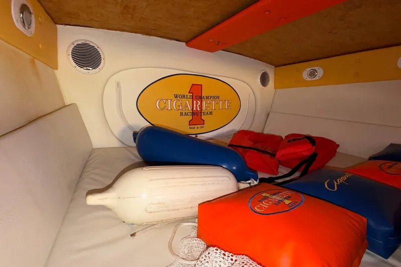 Slide: The Image of Interior of a 2002 Cigarette 35' Cafe Racer with branded cushions and life vests. - 41