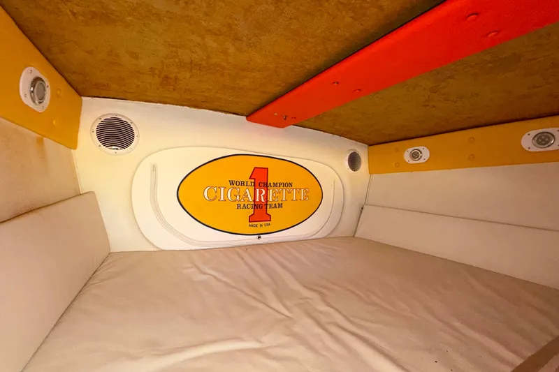 Slide: The Image of Interior cabin of 2002 Cigarette 35' Cafe Racer boat, featuring branded decor and speakers. - 42