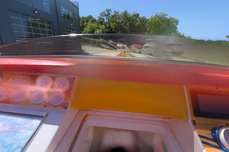 Slide: The Image of Interior view of a 2002 Cigarette 35' Cafe Racer boat dashboard with gauges and windshield. - 43