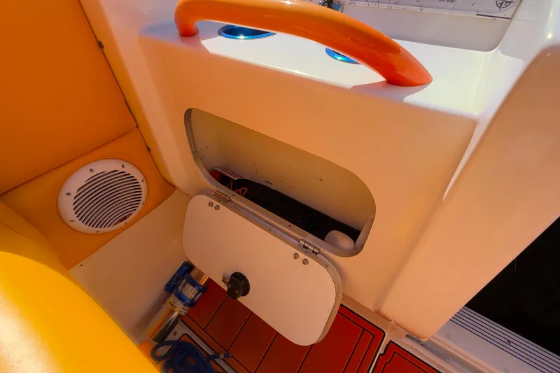 Slide: The Image of Storage compartment and speaker on 2002 Cigarette 35' Cafe Racer boat interior. - 44