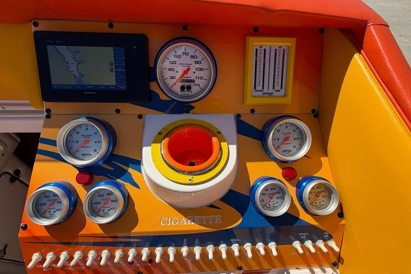 Slide: The Image of Dashboard of a 2002 Cigarette 35' Cafe Racer boat with gauges and controls. - 45