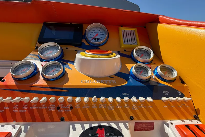 Slide: The Image of Dashboard of a 2002 Cigarette 35' Cafe Racer boat with colorful gauges and controls. - 46