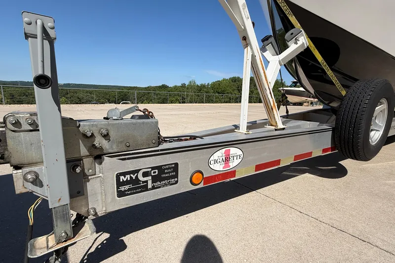 Slide: The Image of Trailer for 2002 Cigarette 35' Cafe Racer boat, parked outdoors on a sunny day. - 47