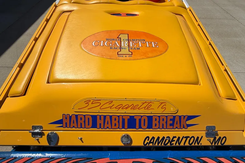 Slide: The Image of 2002 Cigarette 35' Cafe Racer boat, yellow with "Hard Habit to Break" text, Camdenton, MO. - 9