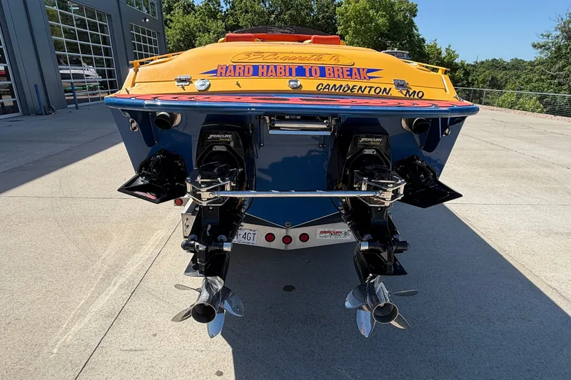 Slide: The Image of 2002 Cigarette 35' Playboy Edition boat, rear view with dual Mercury engines. - 38