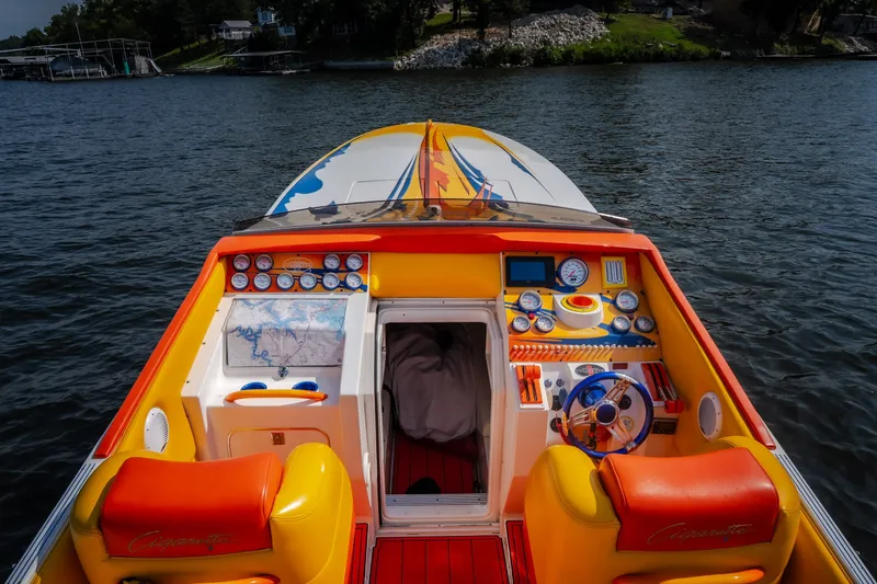 Slide: The Image of 2002 Cigarette 35' Playboy Edition boat interior with vibrant dashboard and steering wheel. - 20