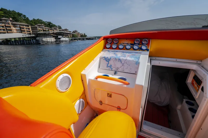 Slide: The Image of 2002 Cigarette 35' Playboy Edition boat interior with vibrant yellow and orange seating. - 30