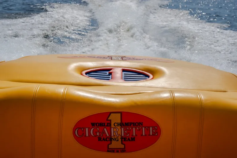 Slide: The Image of 2002 Cigarette 35' Playboy Edition boat on water, showcasing racing team logo. - 11
