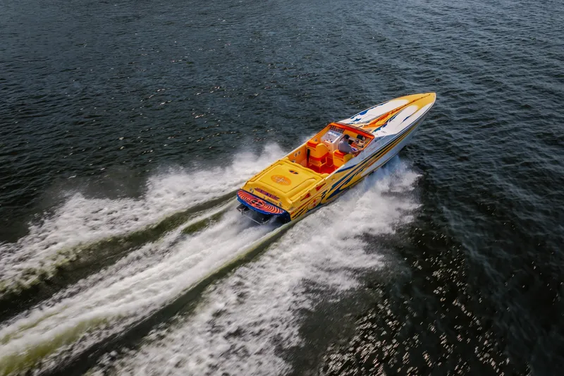 Slide: The Image of 2002 Cigarette 35' Playboy Edition speedboat cruising on open water. - 7