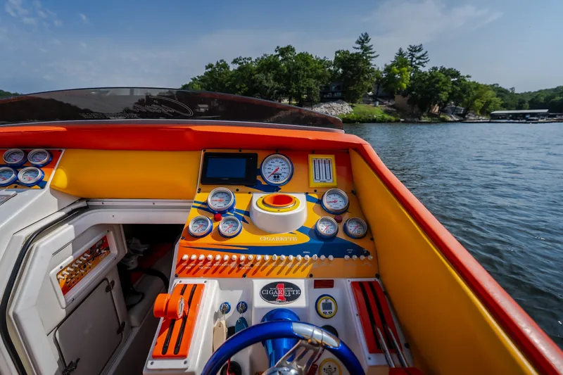 Slide: The Image of Dashboard of a 2002 Cigarette 35' Playboy Edition boat on a scenic lake. - 23