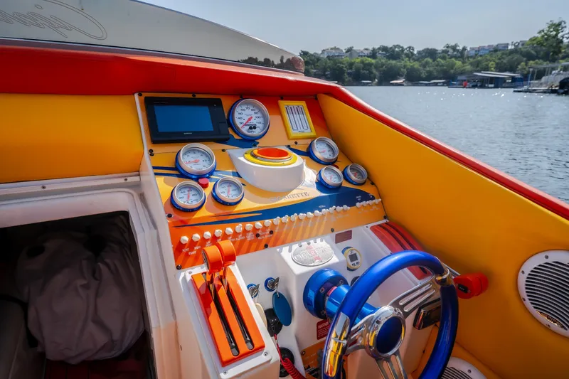 Slide: The Image of Cockpit of 2002 Cigarette 35' Playboy Edition boat with vibrant gauges and controls. - 31