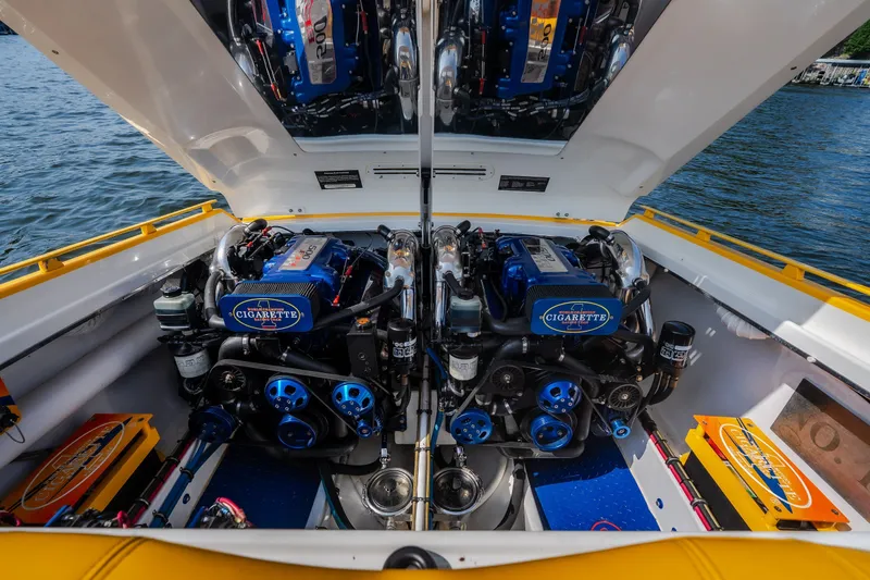Slide: The Image of 2002 Cigarette 35' Playboy Edition boat engine compartment with dual high-performance engines. - 13