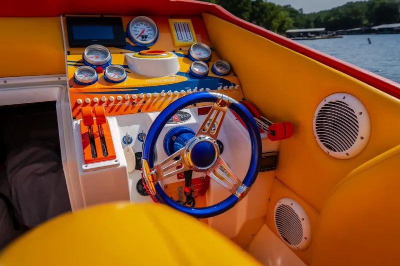 Slide: The Image of Colorful cockpit of a 2002 Cigarette 35' Playboy Edition boat with vibrant controls. - 22