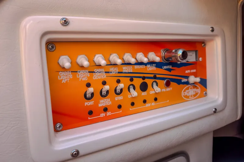 Slide: The Image of Control panel of 2002 Cigarette 35' Playboy Edition boat with various switches and controls. - 33
