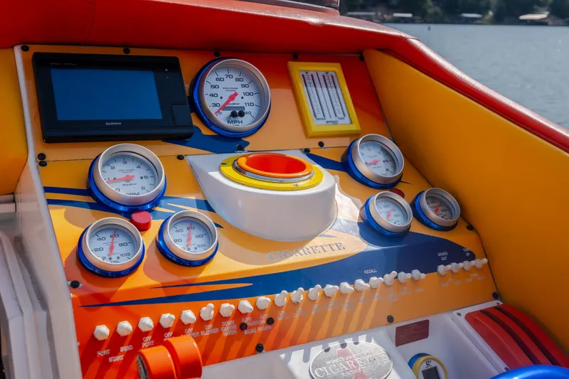 Slide: The Image of Dashboard of a 2002 Cigarette 35' Playboy Edition boat with colorful gauges and controls. - 32