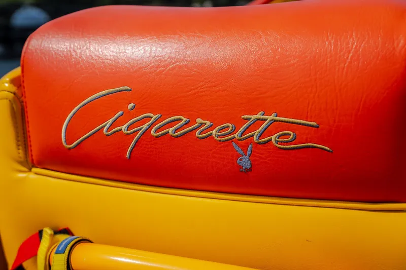Slide: The Image of Orange and yellow leather seat with "Cigarette" and Playboy logo, 2002 edition. - 27