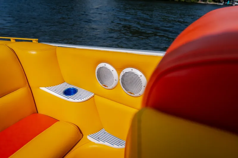 Slide: The Image of Vibrant interior of 2002 Cigarette 35' Playboy Edition boat with yellow and orange seating. - 12