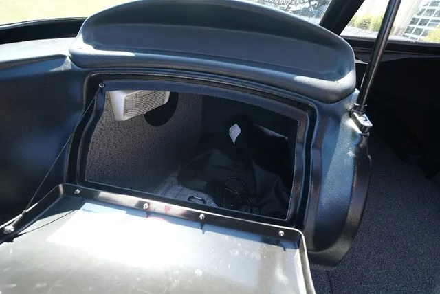 Slide: The Image of An open storage compartment inside a boat with carpeted interior and a small vent grille. - 28