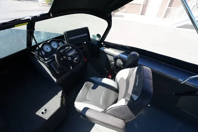 Slide: The Image of The image shows the cockpit of a 2024 Lund 2075 Fisherman with a modern helm and comfortable seating. - 31