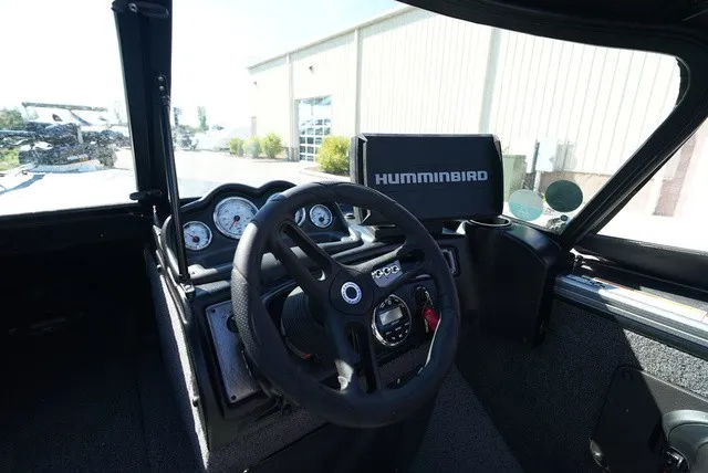 Slide: The Image of The cockpit of a 2024 Lund 2075 Fisherman with a Humminbird fish finder and multiple gauges. - 32