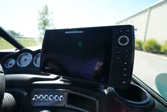 Slide: The Image of The image shows a modern boat dashboard with a Humminbird fish finder and several gauges. - 33