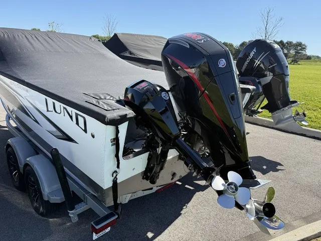 Slide: The Image of A 2024 Lund 2075 Fisherman boat with two outboard motors on a trailer. - 24