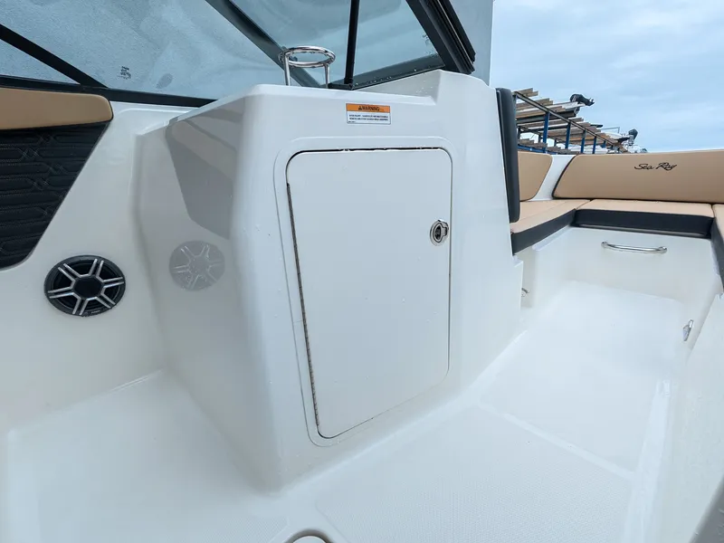 Slide: The Image of The image shows the cockpit of a 2027 Sea Ray SPX 210 Outboard with white and beige details. - 17
