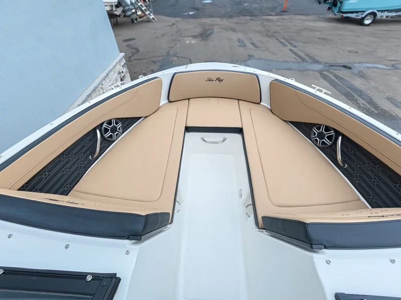 Slide: The Image of The image shows the bow of a Sea Ray SPX 210 Outboard with beige cushions and speakers. - 19