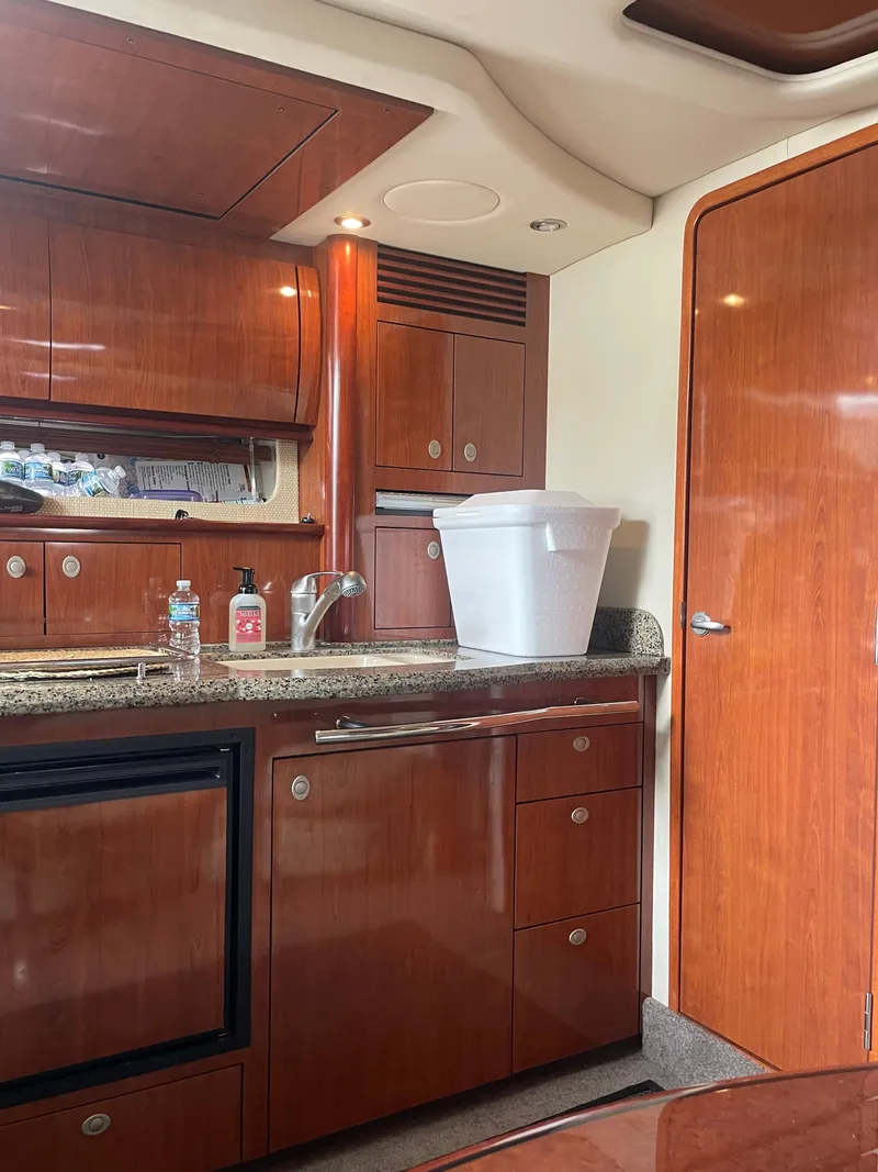 Slide: The Image of Interior of a yacht with wooden cabinetry and a small kitchen area. - 18