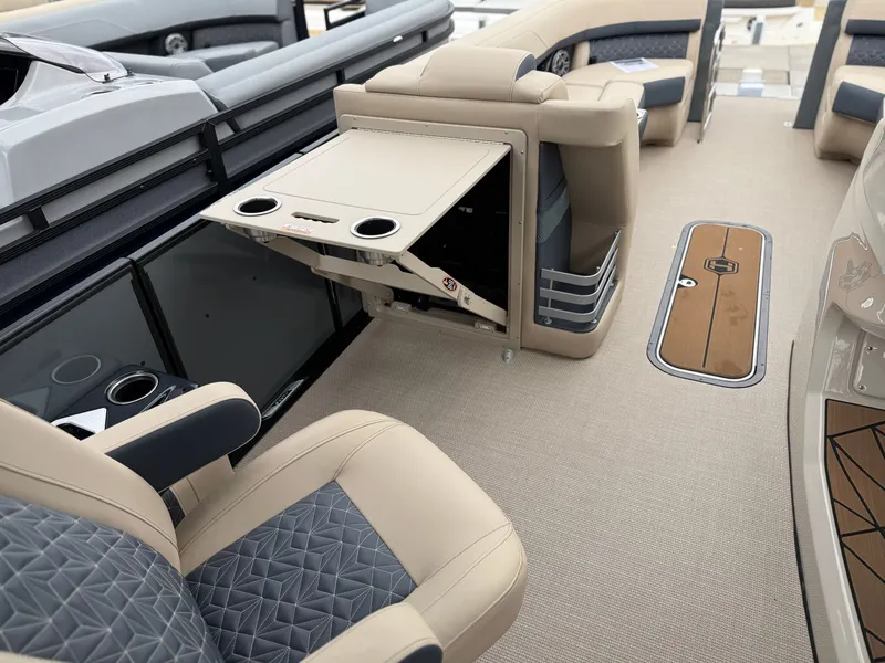 Slide: The Image of The image shows the interior of a 2027 Harris Grand Mariner 250 with luxurious seating and a fold-out table. - 13