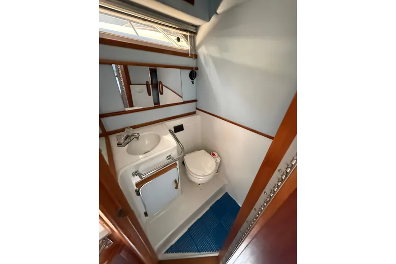 Slide: The Image of Compact bathroom in 1987 Sea Ray 300 Weekender boat, featuring sink and toilet. - 15