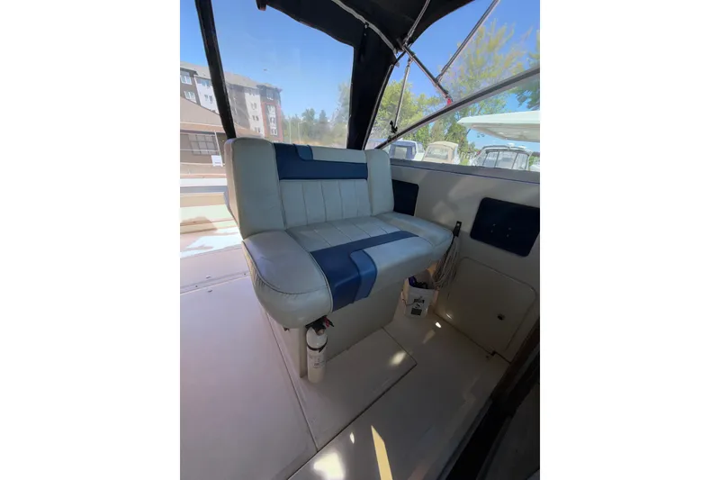 Slide: The Image of 1987 Sea Ray 300 Weekender interior with blue and white seating under canopy. - 2