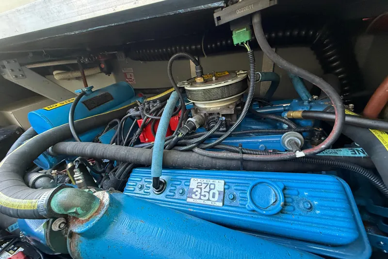 Slide: The Image of Engine compartment of a 1987 Sea Ray 300 Weekender boat, showcasing detailed components. - 23
