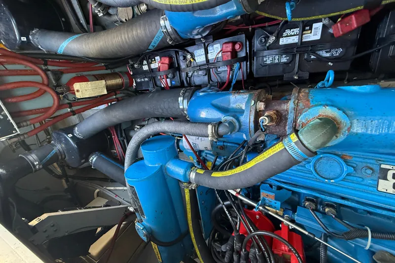 Slide: The Image of Engine compartment of a 1987 Sea Ray 300 Weekender with visible hoses and wiring. - 24