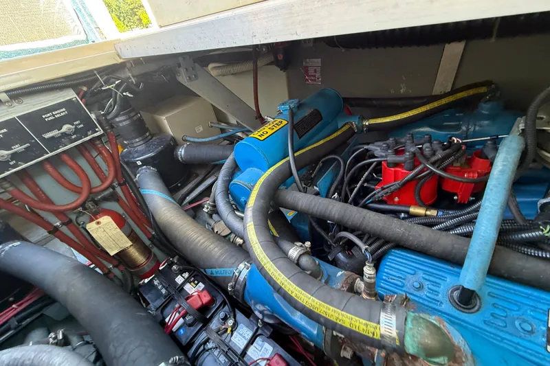 Slide: The Image of Engine compartment of a 1987 Sea Ray 300 Weekender boat, showcasing wiring and components. - 25