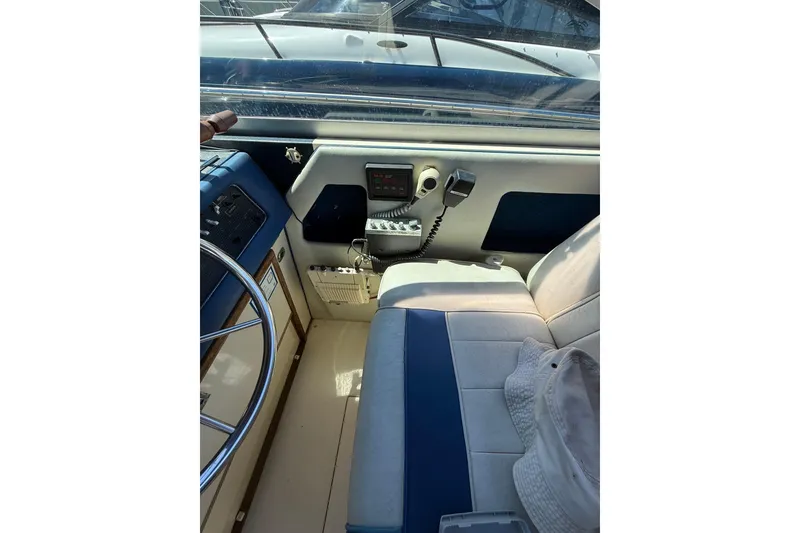 Slide: The Image of 1987 Sea Ray 300 Weekender helm with steering wheel, controls, and seating. - 3