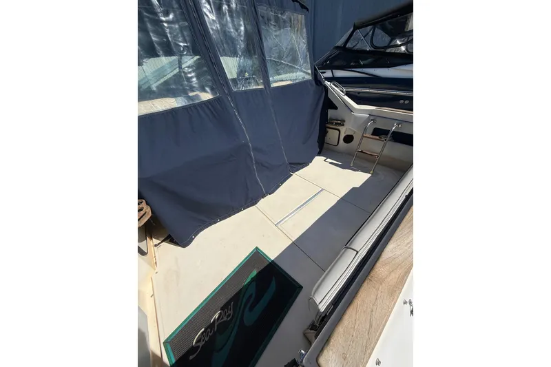 Slide: The Image of 1987 Sea Ray 300 Weekender boat interior with seating and protective cover. - 5