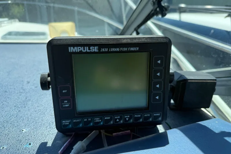Slide: The Image of Impulse 2830 Loran/Fish Finder on 1987 Sea Ray 300 Weekender boat dashboard. - 8