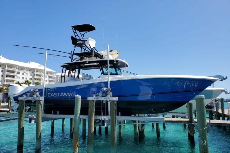 The Image of 2019 HCB 42 Siesta boat docked, blue hull, clear water, sunny day. - 1