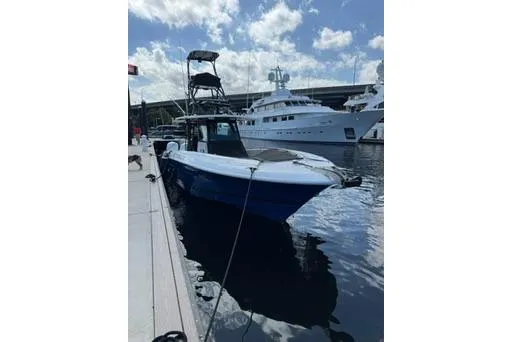 Slide: The Image of 2019 HCB 42 Siesta boat docked at marina under cloudy sky. - 7