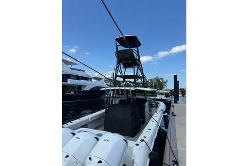 Slide: The Image of 2019 HCB 42 Siesta boat docked, featuring a tall tower and clear blue sky. - 8