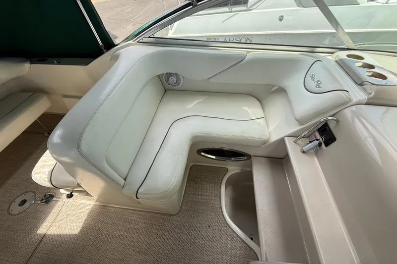 Slide: The Image of 2004 Sea Ray 240 Sundancer interior with white seating and cup holders. - 11