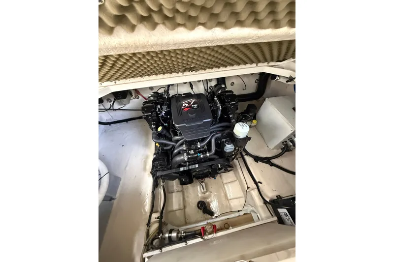 Slide: The Image of Engine compartment of a 2004 Sea Ray 240 Sundancer boat, showcasing the motor and components. - 22