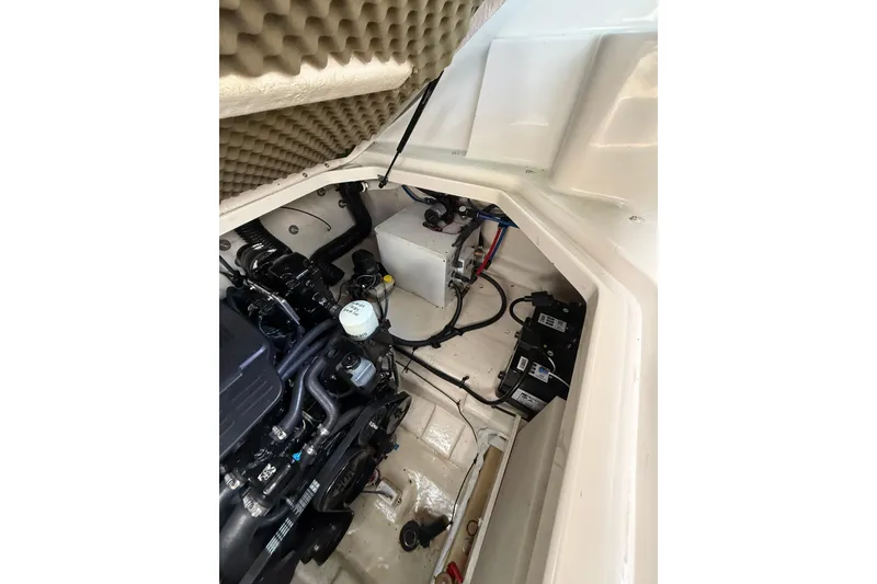 Slide: The Image of Engine compartment of a 2004 Sea Ray 240 Sundancer boat, showcasing mechanical components. - 23