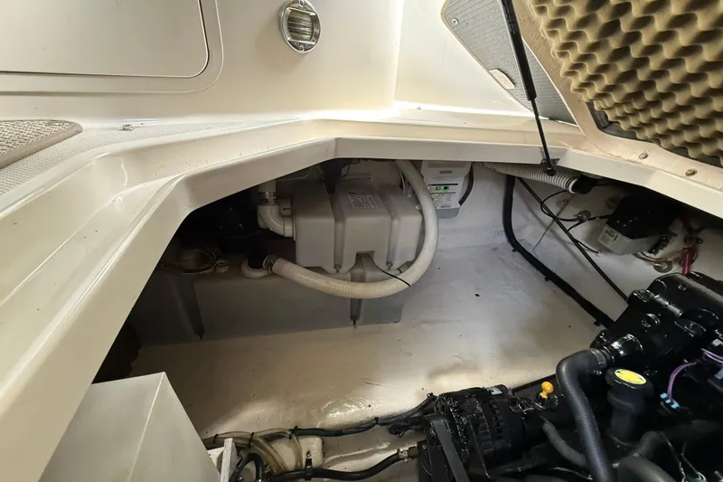 Slide: The Image of Engine compartment of a 2004 Sea Ray 240 Sundancer boat, showcasing mechanical components. - 24