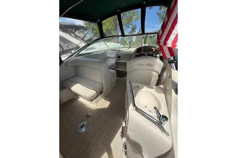 Slide: The Image of Interior of a 2004 Sea Ray 240 Sundancer boat with seating and steering wheel. - 6