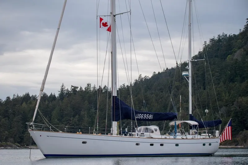 The Image of Sailing yacht Abeking & Rasmussen Tripp 74, 1968, anchored with Canadian and American flags. - 0