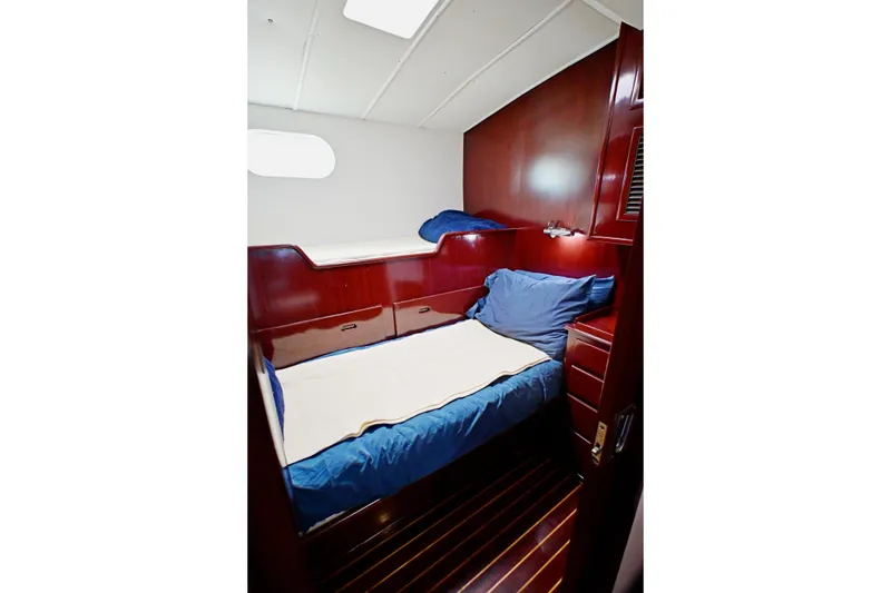 Slide: The Image of Cozy cabin interior of 1968 Abeking & Rasmussen Tripp 74 yacht with wooden finish and blue bedding. - 14