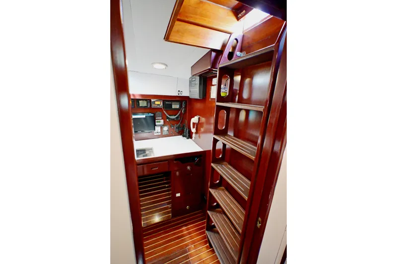 Slide: The Image of Interior of 1968 Abeking & Rasmussen Tripp 74 yacht with wooden cabinetry and navigation equipment. - 16