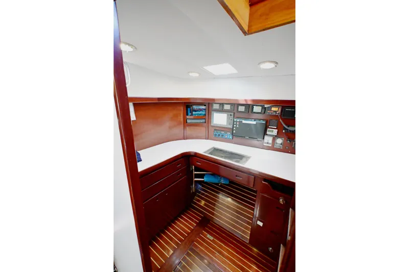 Slide: The Image of Navigation station of 1968 Abeking & Rasmussen Tripp 74 yacht with wood paneling and instruments. - 17